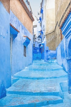 Blue staircase in a narrow street in the city of Chefchaouen. Morocco. Vertically.