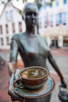 View of a bronze figure with a coffee cup in front of a well-known coffee roastery in the northern German city of Leer.