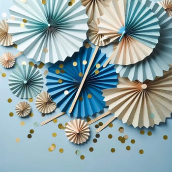 A flat lay composition of blue and beige paper fans, with golden confetti scattered around them. The scene is set against a light blue background. A high-quality photo.