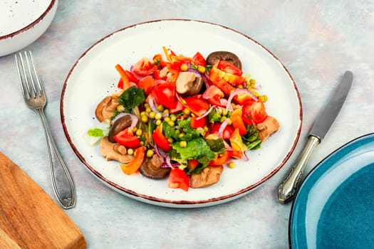 Dietary vegetable salad with marinated pickled mushrooms, green peas in bowl. Space for text.