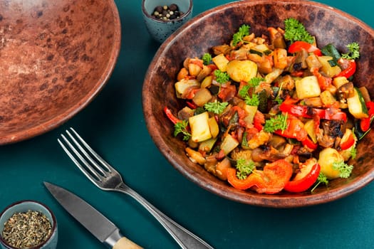 French vegetable dish, ratatouille. Baked eggplants, zucchini, peppers and tomatoes.