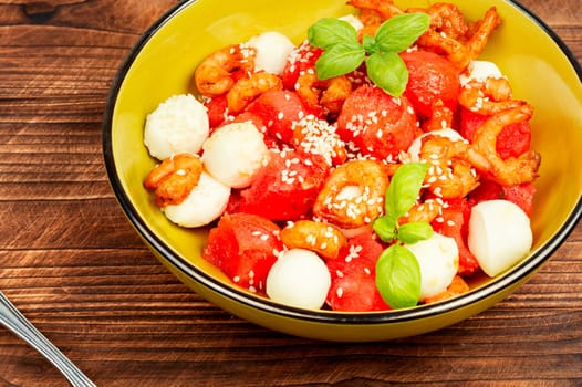 Fresh salad with watermelon, mozzarella cheese and shrimp.