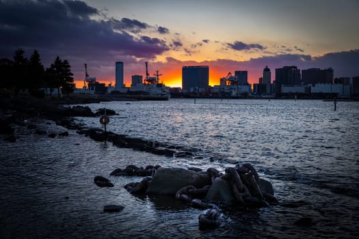 Odaiba, japan cityscape sunset  water and rusty chains tokyo