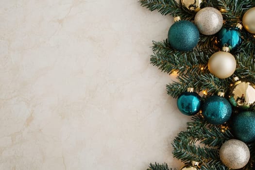 Beautifully arranged Christmas tree ornaments in shades of teal, gold, and green adorn a clean, solid surface, enhancing the holiday spirit and providing a festive atmosphere during the season.