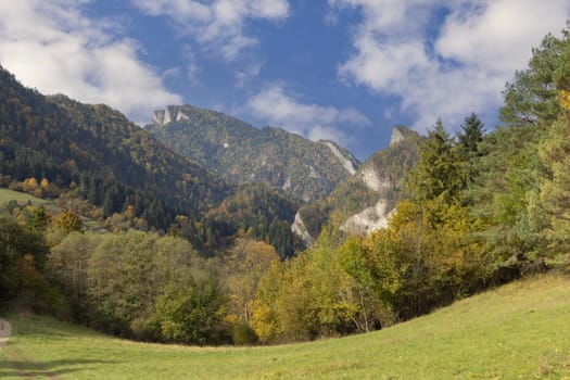 Panoramic view of the autumn landscape in the Pieniny Mountains, colorful leaves on the trees, Szczawnica, Poland. Three Crowns Massif (Trzy Korony) in a distance