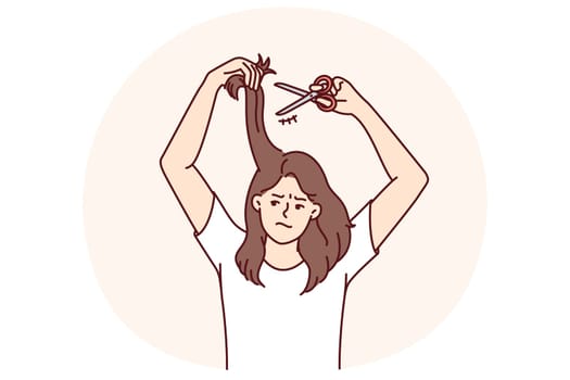 Woman cuts own hair because of dissatisfaction with hairstyle and split ends that appeared due to bad shampoo. Unhappy casual girl needs professional hairdresser or better shampoo.