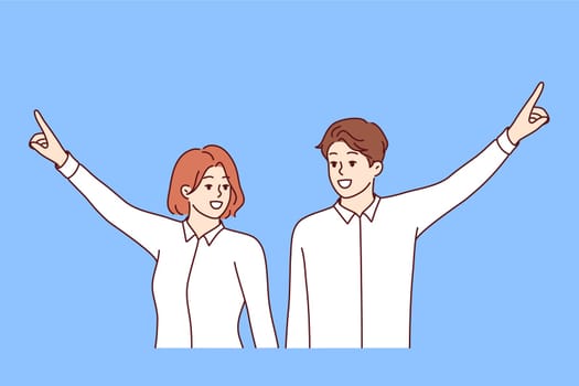 Team of two business people raise hands in victory and point upward, demonstrating commitment to achieving higher goals. Team job of company employees choosing direction of company work