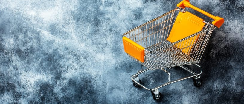 A shopping cart with orange accents against a textured blue background, offering ample copy space.
