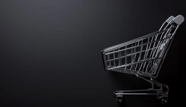 Empty metal shopping cart isolated on a dark background with copy space, symbolizing e-commerce and online shopping concepts.
