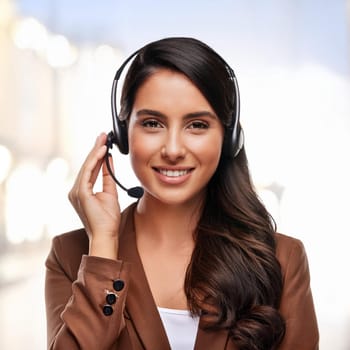 beautiful smiling woman with headset in a call centre