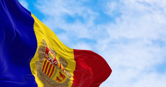 Flag of the Principality of Andorra waving in the wind on a clear day. Vertical blue-yellow-red stripes with coat of arms in center. 3d illustration render. Rippled fabric.