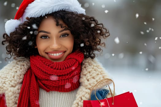 A young woman, wearing a festive Santa hat and a cozy red scarf, smiles brightly amidst falling snowflakes as she holds a shopping bag filled with colorful holiday gifts.