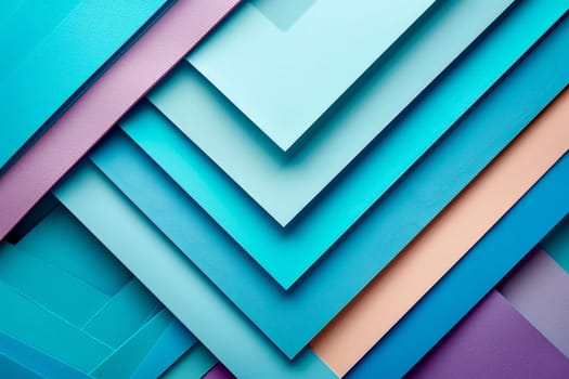 An arrangement of layered paper in varying shades of blue, teal, and purple displays an artistic blend of colors and textures, highlighting the depth and visual interest of the composition.