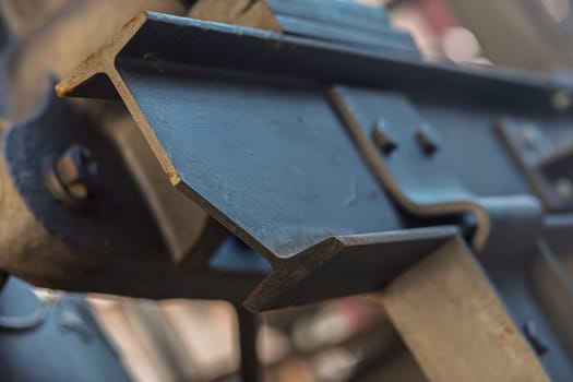 Close up of a welded i beam forming a strong steel structure, showcasing the details of welding and joining of traditional metal parts
