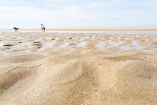 Sand on the beach at De Haan on the Belgian North Sea coast at low tide