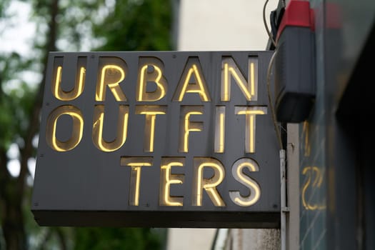 Neon sign for lifestyle retailer Urban Outfitters in the city center of Cologne in Germany