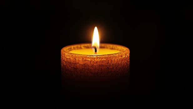 Burning candle in the dark. Concept of memory, hope, and remembrance.