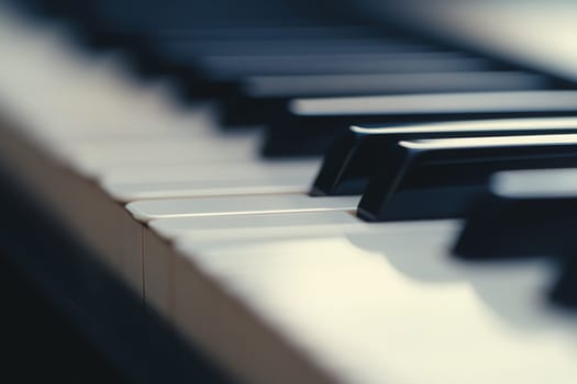 A close-up view of piano keys showcases the elegant stark contrast between black and white keys. The smooth, clean surface highlights the artistry of the piano, inviting a touch of musical grace.