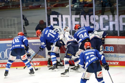 Hard-fought game,also on the boards there was a hard duel for the puck in the game of the DEL 24-25,10th Sptg.: Schwenninger Wild Wings vs Iserlohn Roosters