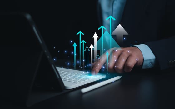 Business growth, Progress or success concept, Businessman use tablet showing a growing virtual hologram of analytics dashboard with charts, Stock market, Invest in trading, Finance, Marketing.