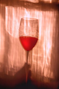 Wine glass raised in a toast.