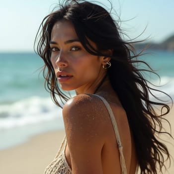 A brunette woman in a swimsuit gazes back while standing near the shoreline. Gentle sea waves lap at her feet under a clear blue sky. Long hair, beautiful young face. Travel and clothing adverts. AI.
