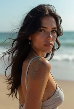 A brunette woman in a swimsuit gazes back while standing near the shoreline. Gentle sea waves lap at her feet under a clear blue sky. Long hair, beautiful young face. Travel and clothing adverts. AI.