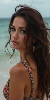 A brunette woman in a swimsuit gazes back while standing near the shoreline. Gentle sea waves lap at her feet under a clear blue sky. Long hair, beautiful young face. Travel and clothing adverts. AI.