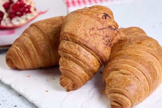 Baked croissants on white table, breakfast