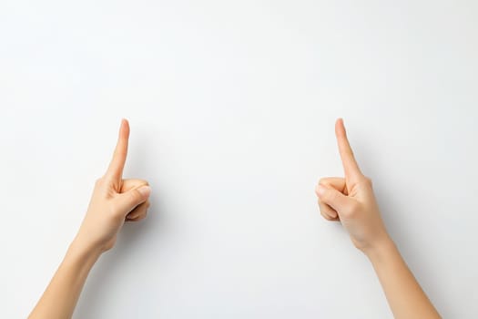 A pair of hands displays crossed fingers against a bright white backdrop, signifying a gesture of hope and good luck. This simple yet powerful symbol evokes positive feelings.