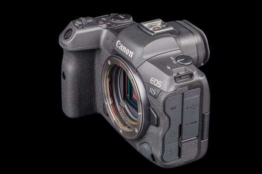 Canon R5 - black professional 35mm full-frame mirrorless camera body with flip screen isolated on black background with focus stacking - Tula, Russia, September 15, 2021