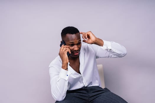 Happy african american young businessman in a formal suit portrait. Confident black guy posing