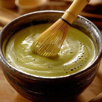 A high-resolution, photorealistic stock image of traditional matcha tea preparation. The scene captures the rich green matcha powder being whisked into a smooth, frothy tea using a bamboo whisk (chasen) in a ceramic bowl. The image, taken with a Hasselblad X2D camera, focuses on the fine details of the matcha powder, the texture of the bowl, and the delicate foam on the teaâ€™s surface. Soft, natural lighting highlights the vibrant green color of the matcha, while the background remains minimal and serene, reflecting the ritualistic nature of the tea ceremony --chaos 20 --style raw --stylize 300 --v 6.1 Job ID: de68ea75-fbcd-44a7-870f-04901012649f