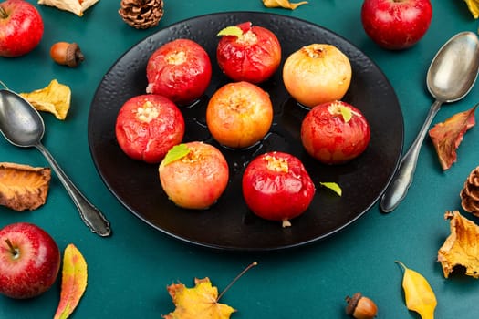 Tasty baked apples with nuts on a plate. Rustic style.