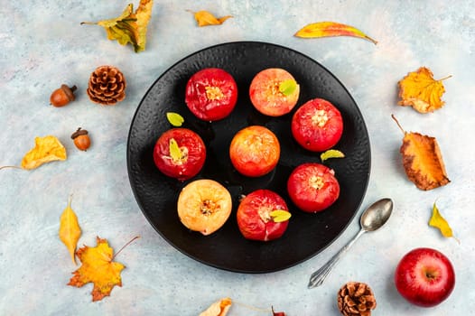 Tasty baked apples with nuts on a plate. Rustic style.