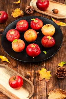 Tasty baked apples with nuts on a plate. Rustic style.