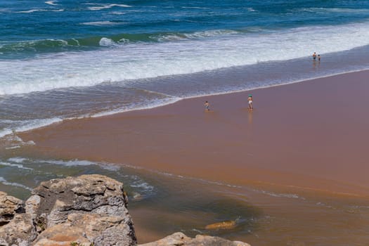 Sintra, Portugal: April 13, 2024: People at the beach of Foz do Lizandro, Ericeira, Portugal