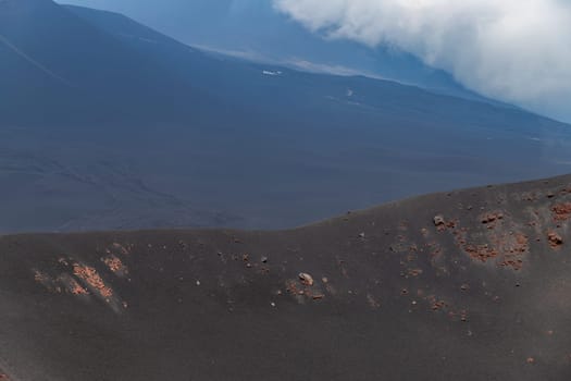 The Etna volcano. The Etna volcano crater. Black Volcanic Earth, Volcanic Lava and Stones. Dense Fog on Mount Etna. The island of Sicily, Italy.
