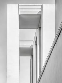 Abstract view of white modern architecture featuring clean lines, geometric shapes, and subtle shadows, creating a minimalist and contemporary aesthetic.
