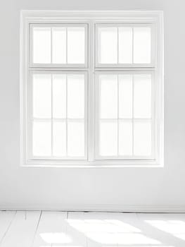 A pristine white window frame with multiple panes casts geometric shadows on a white wall and floor, creating a clean and airy interior scene.