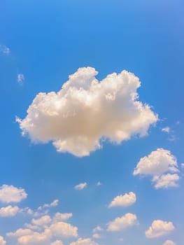 Majestic white cumulus clouds float in a bright blue sky, creating a serene and peaceful atmosphere. Perfect for backgrounds or concepts of freedom and tranquility.