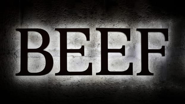 illuminated lettering Beef as a reference to a steakhouse on the facade of a building