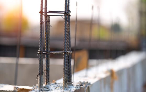 Concrete footings and reinforcing steel rods at a construction site. Groundwork for new building foundation. Reinforcement steelwork providing strength and stability for long term structural integrity