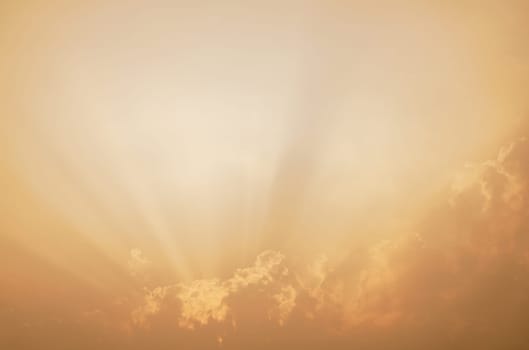 Dramatic orange sky with sunlit clouds creates ethereal abstract background. Tranquil beauty of sunset for inspirational imagery. Spiritual and nature-themed designs. Ideal for meditation apps.