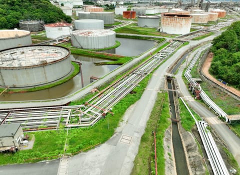 Aerial view of crude oil storage tank and pipeline system in a modern petrochemical plant. Efficient storage and transportation infrastructure in the oil and gas industry for safe fuel handling.