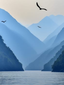 Majestic blue mountains rise above a tranquil lake, with silhouettes of birds soaring against a misty sky, creating a peaceful and awe inspiring natural scene.