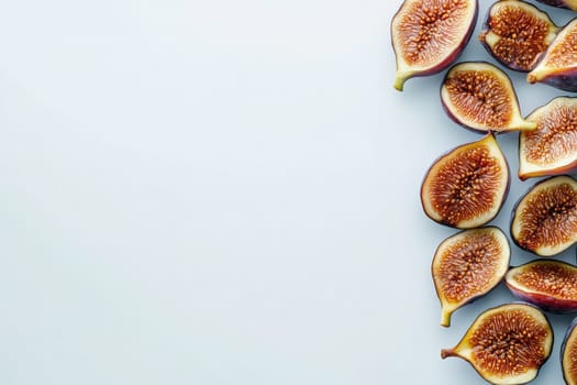 A collection of dried figs lies neatly on a white surface, showcasing their rich texture and color. These fruits highlight their natural sweetness and are ideal for various health-conscious recipes.