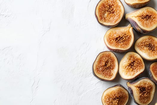 A collection of dried figs is elegantly arranged on a pristine white background, highlighting their unique shapes and rich, textured interiors.