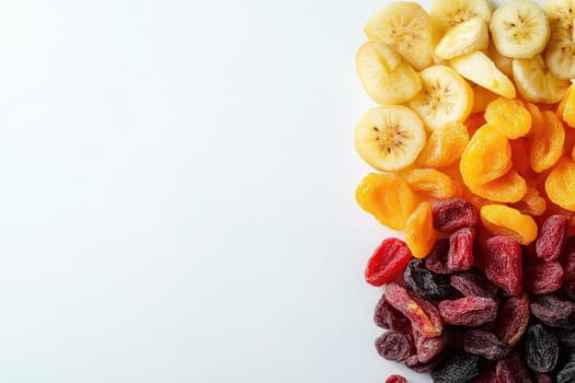 A vibrant assortment of dried fruits, including banana slices, apricots, and mixed berries, is neatly arranged on a solid white background, showcasing their appealing colors and textures.