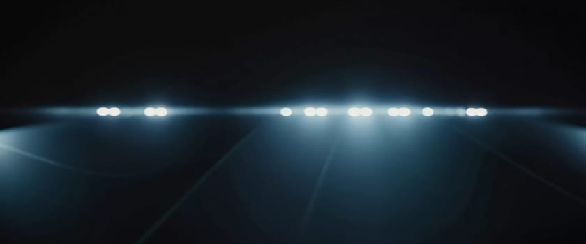 Smooth black backdrop accentuated by soft blue anamorphic bokeh effects. Gentle light waves flow across the surface, creating an ethereal atmosphere. Generative AI.